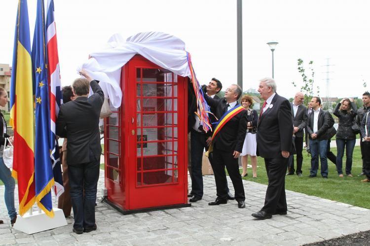 Cabina telefonică inaugurată de Emil Boc în 2013, după delegația din Anglia alături de Simona Baciu (în dreapta lui Emil Boc, cu fusta albă). Foto: știridecluj.ro