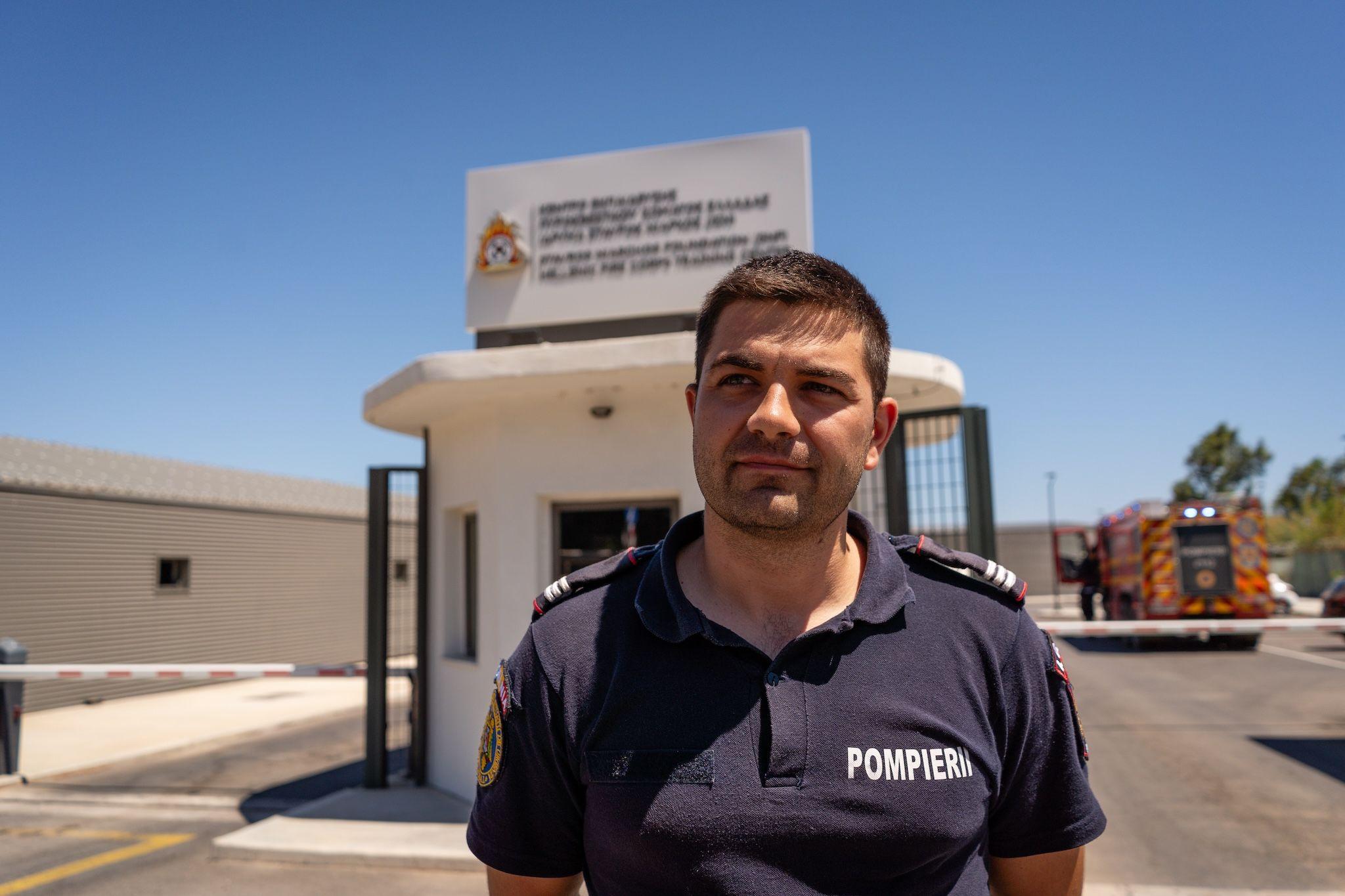 A Romanian firefighter stands outside the fire station in Nea Makri, Athens, on August 13, 2024, after assisting in the ongoing battle against the wildfire that broke out in East Attica on Sunday. Photo: Ioana Epure