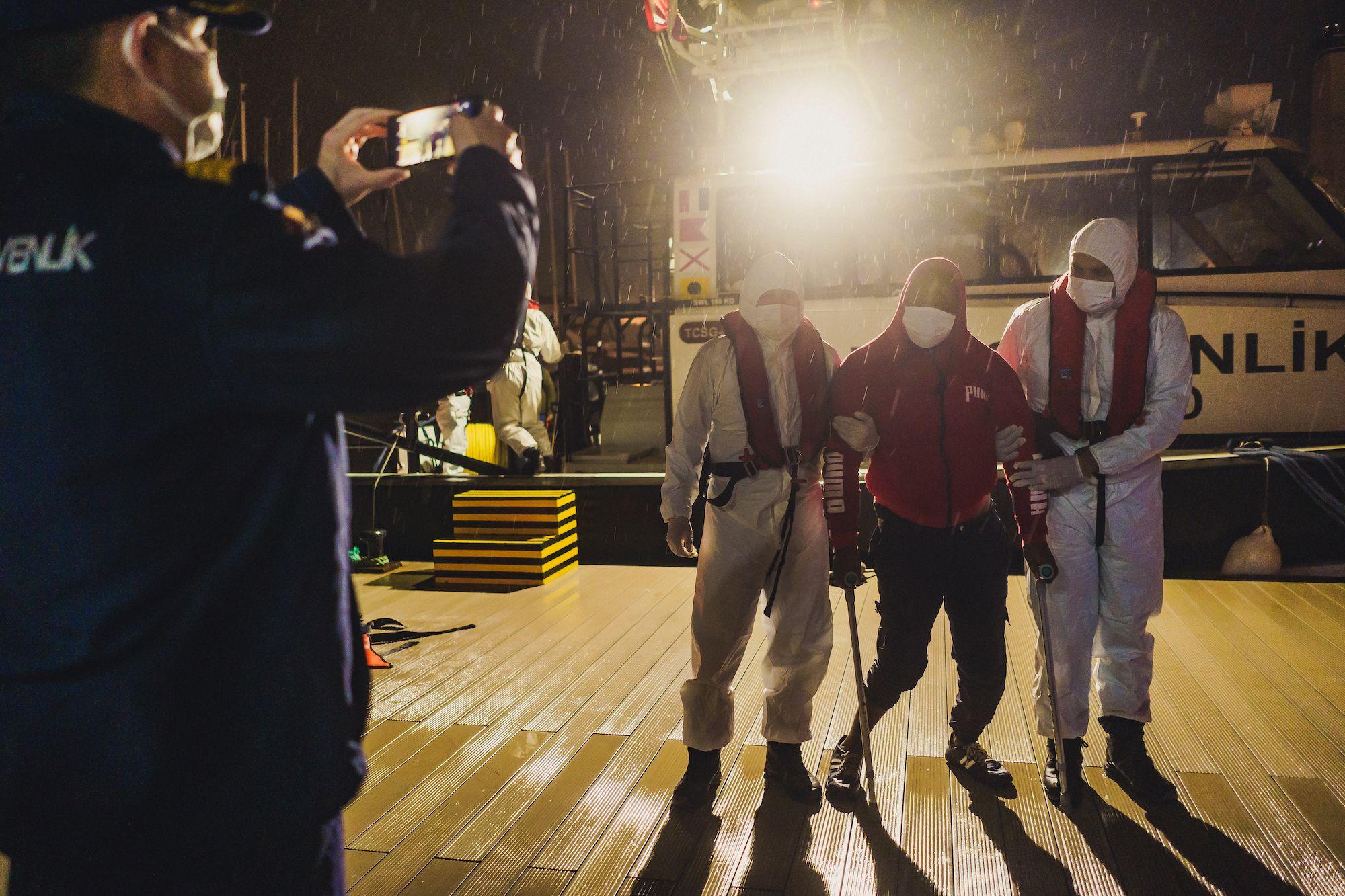 The Turkish Coast Guard photographs the people recovered from the sea for their database. Photo: Ioana Epure