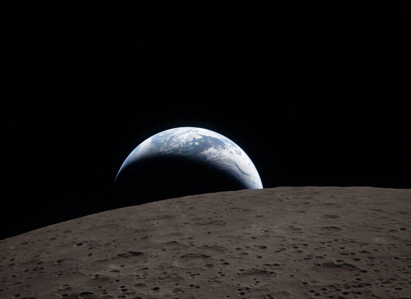art002e009288 (April 6, 2026) – Earthset captured through the Orion spacecraft window at 6:41 p.m. EDT, April 6, 2026, during the Artemis II crew’s flyby of the Moon. A muted blue Earth with bright white clouds sets behind the cratered lunar surface.
The dark portion of Earth is experiencing nighttime. On Earth’s day side, swirling clouds are visible over the Australia and Oceania region.
In the foreground, Ohm crater has terraced edges and a flat floor interrupted by central peaks. Central peaks form in complex craters when the lunar surface, liquefied on impact, splashes upwards during the crater’s formation.