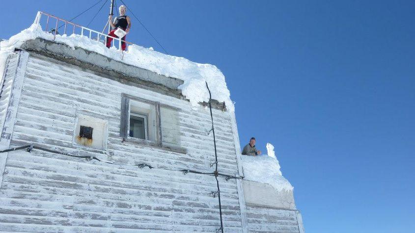Radu Manta și colegul său de tură deszăpezesc stația meteorologică Omu.