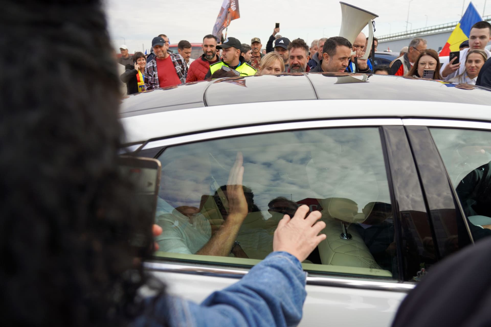 Ascuns în mașină, fostul candidat extremist la alegerile prezidențiale îi salută pe cei veniți la întâlnirea de duminică dimineață. Foto: Raul Ștef