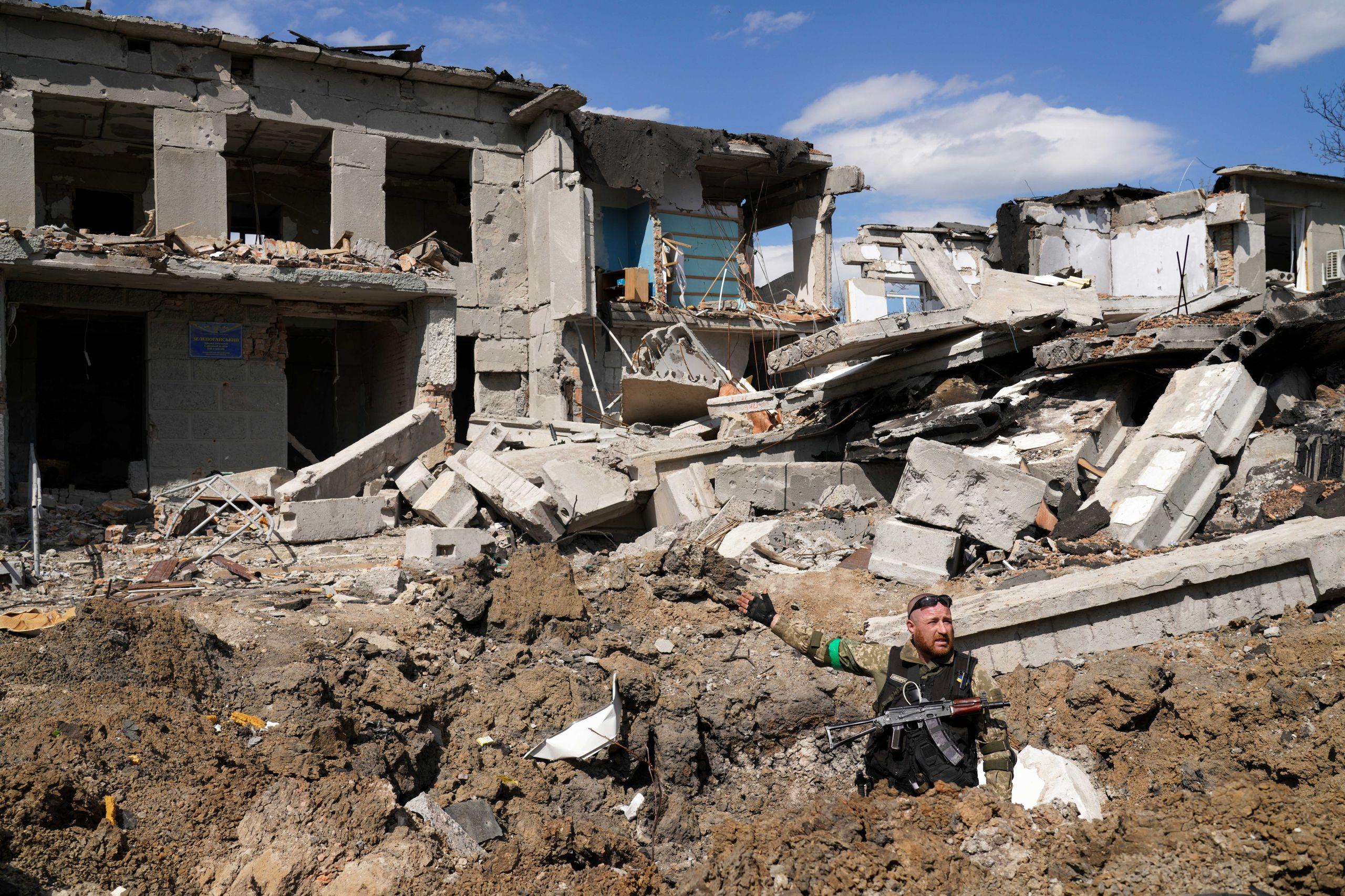 Yuri, in front of a destroyed school.  Photo: Raul Ștef