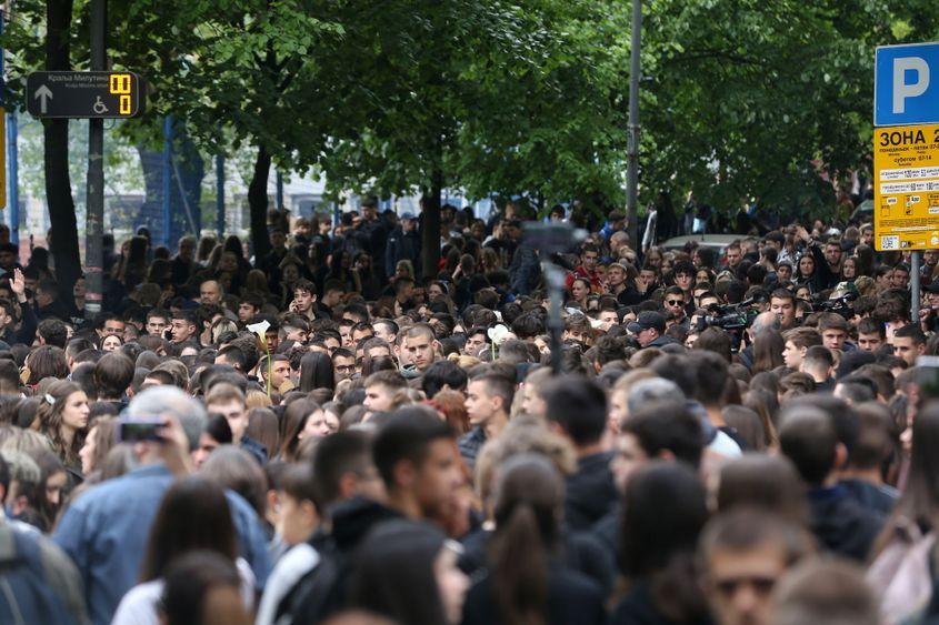 People gather to leave flowers and light candles in memory of the victims in front of "Vladislav Ribnikar" primary school in Belgrade, Serbia, May 4, 2023. A teenage student shot dead seven girls, a boy and a security guard using two guns he had taken from his father. Six children and a teacher were also injured in the attack. EPA/ANDREJ CUKIC