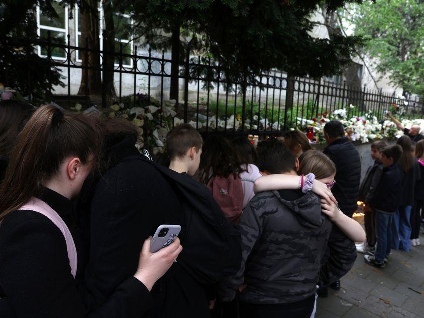 Children embrace in front of the "Vladislav Ribnikar" primary school in Belgrade, Serbia, May 4, 2023. A teenage student shot dead seven girls, a boy and a security guard using two pistols he had taken from his father. Six children and a teacher were also injured in the attack. EPA/ANDREJ CUKIC