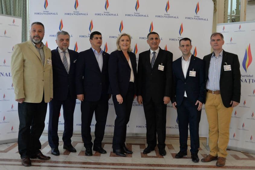 Panoul cu sigla „Partidul Forța Națională”. Colonelul SPP Găinușă e al doilea din stânga.
