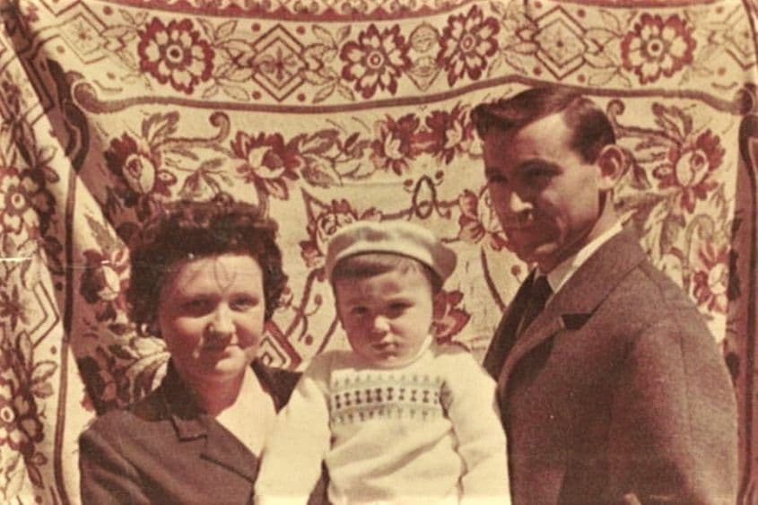 Mugur Călinescu, copil, cu părinții săi. Ca și în viață, în comunism, un covor maschează realitatea