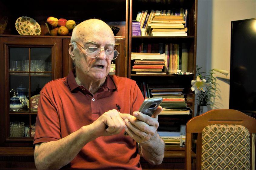 Profesorul abia vede să scrie pe telefon.
