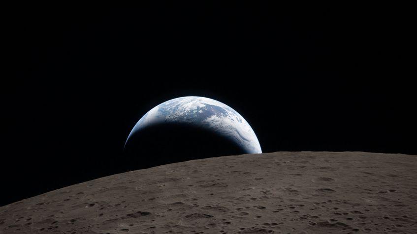 art002e009288 (April 6, 2026) – Earthset captured through the Orion spacecraft window at 6:41 p.m. EDT, April 6, 2026, during the Artemis II crew’s flyby of the Moon. A muted blue Earth with bright white clouds sets behind the cratered lunar surface.
The dark portion of Earth is experiencing nighttime. On Earth’s day side, swirling clouds are visible over the Australia and Oceania region.
In the foreground, Ohm crater has terraced edges and a flat floor interrupted by central peaks. Central peaks form in complex craters when the lunar surface, liquefied on impact, splashes upwards during the crater’s formation.